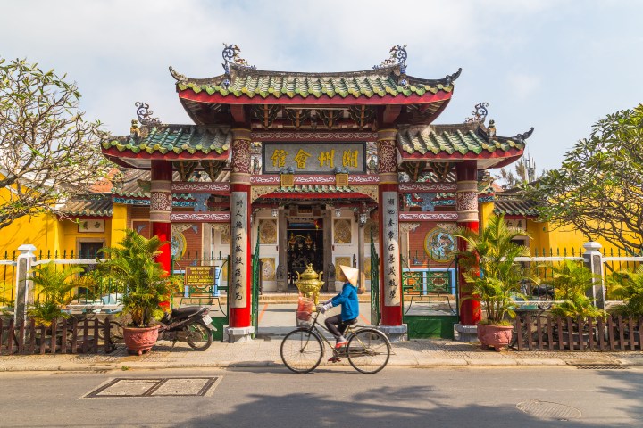 Girl riding a bike in Hoi An Vietnam